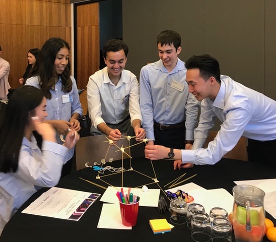 Participants building a tower with spaghetti